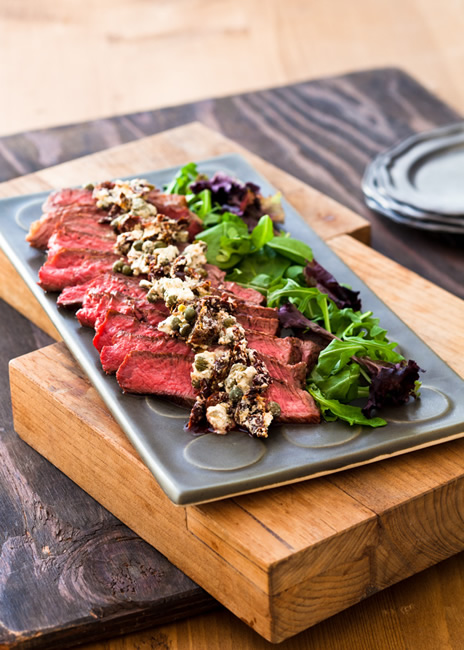 Beef tenderloin with goat cheese sun dried tomato and caper topping